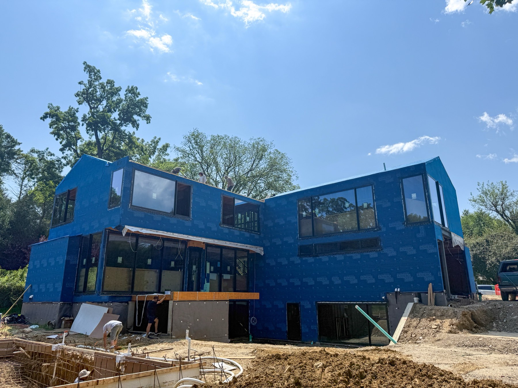 House exterior wrapped in weather barrier and secured before siding