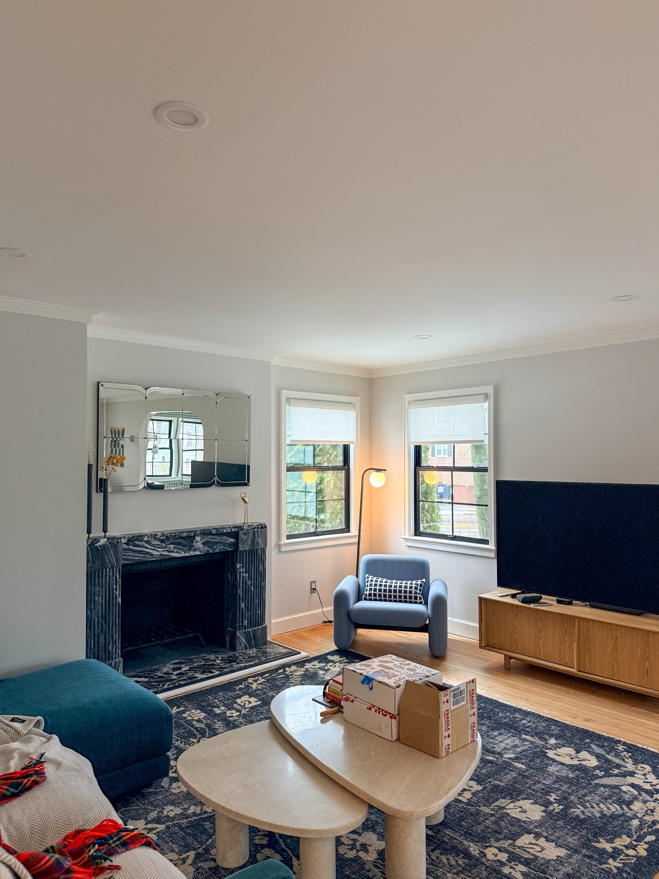 Living room remodel with black marble fireplace surround