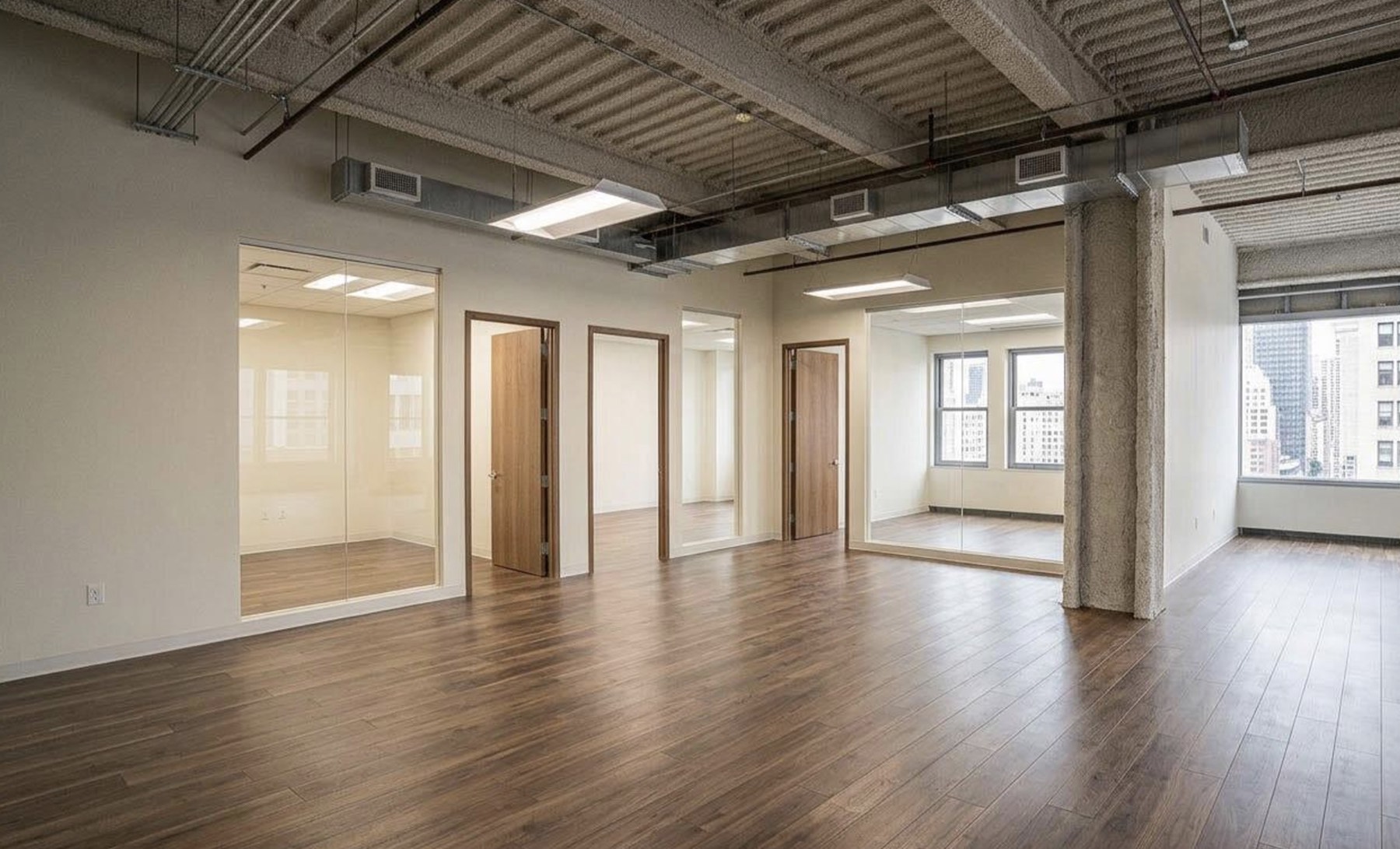 Finished NYC office build-out with glass partitions and city views